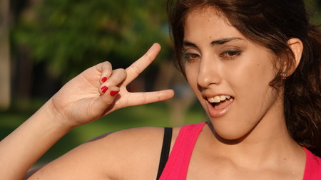 Youthful Latina Woman And Peace Signの写真素材