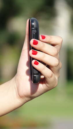 Female Hand With Cell Phone Deviceの写真素材