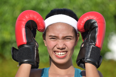 Stressful Female Athlete Wearing Boxing Glovesの写真素材