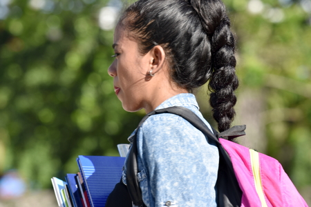 Female Student With Braided Hair With Books