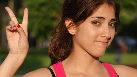 Beautiful Hispanic Female And Peace Signの写真素材