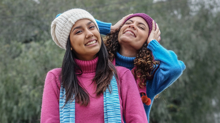 Teen Hispanic Girls Having Fun During Winterの写真素材