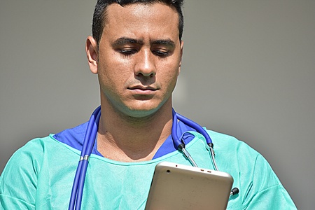 Unemotional Handsome Male Doctor Wearing Scrubs