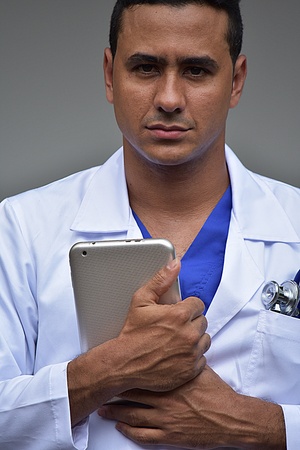 Unemotional Intelligent Male Doctor With Tabletの写真素材