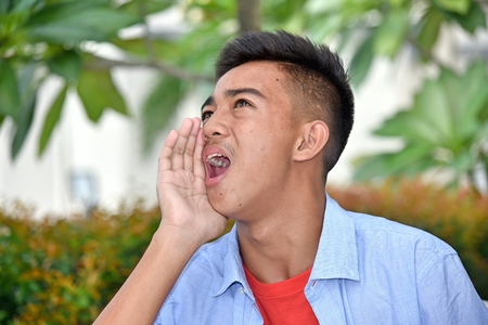 Handsome Minority Male Youngster Shoutingの写真素材