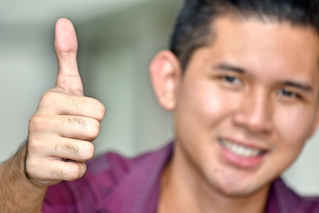 Young Minority Man With Thumbs Upの写真素材