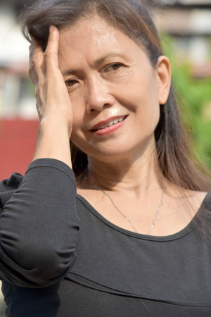 Thoughtful Filipina Female Seniorの写真素材