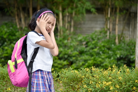 Young Minority Female Student Under Stress Wearing School Uniformの写真素材