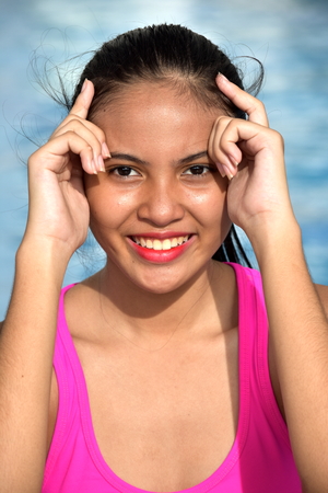 Young Asian Youth And Happiness Sitting By Poolの写真素材