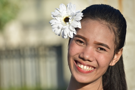 Minority Female Smiling With Flowerの写真素材