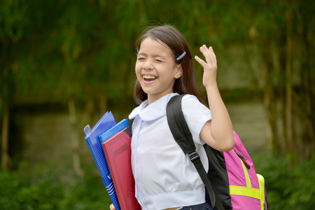 Filipina Girl Student Laughing With Notebooksの写真素材