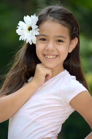 Cute Minority Female Smiling With A Flowerの写真素材