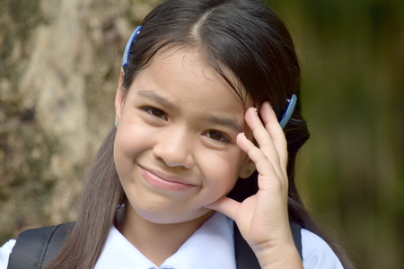 Student Child Wondering Wearing Uniform With Booksの写真素材