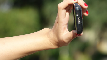 Female Hand Taking Photo With Phoneの写真素材