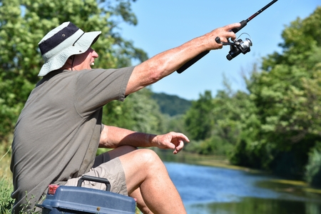 Male Fisherman And Excitement With Fishing Rod Casting Rodの写真素材
