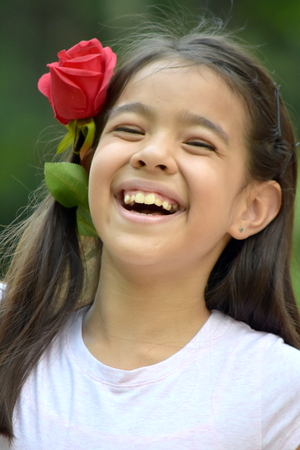 Preteen And Laughter With A Roseの写真素材