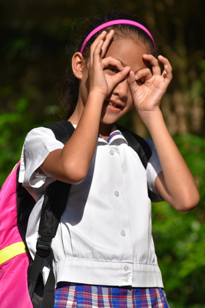 Young Female Student Searching Wearing School Uniform With Booksの写真素材