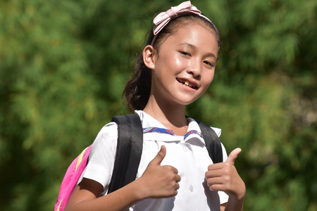 Proud Youthful Asian Person With Notebooksの写真素材