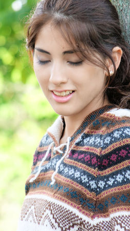Beautiful Female With Eyes Closed Wearing Sweaterの写真素材