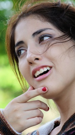 Youthful Latina Adult Female Thinkingの写真素材