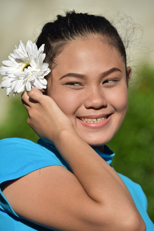 Attractive Minority Adult Female And Happiness With A Daisyの写真素材