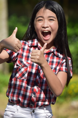 Diverse Girl With Thumbs Upの写真素材