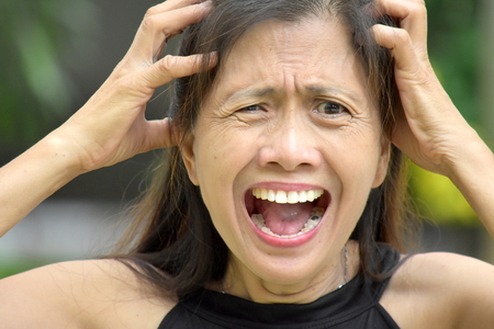 Stressful Older Asian Adult Femaleの写真素材