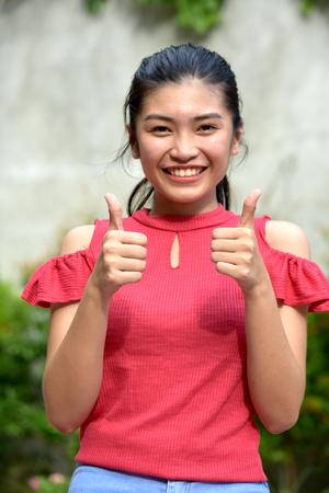 Pretty Filipina Juvenile With Thumbs Upの写真素材