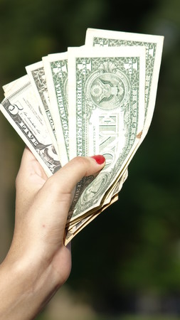 Female Hand Holding Cash Dollarsの写真素材