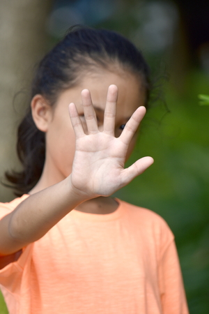 Diverse Female Youngster Gesturing Stopの写真素材