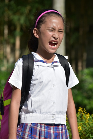 Catholic Minority Female Student Shouting With Notebooksの写真素材