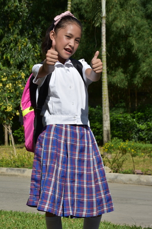 Girl Student With Thumbs Up With Booksの写真素材