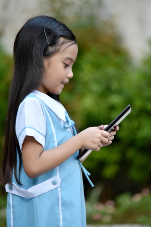 Pretty Catholic Filipina Girl Student With Tabletの写真素材