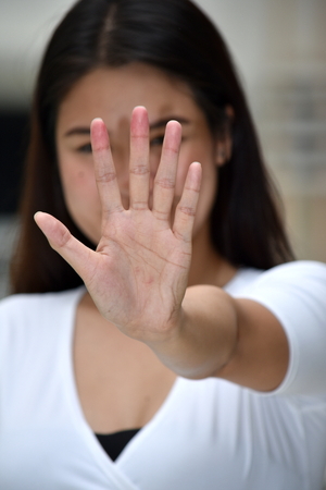 Attractive Filipina Adult Female Gesturing Stopの写真素材