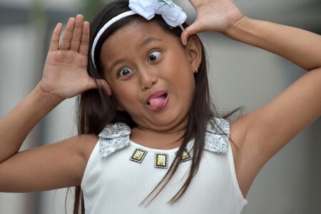 Youthful Juvenile Making Funny Facesの写真素材