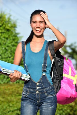 Confused School Girl Student With Notebooksの写真素材