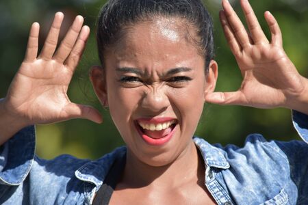 Young Asian Adult Female Making Funny Facesの写真素材