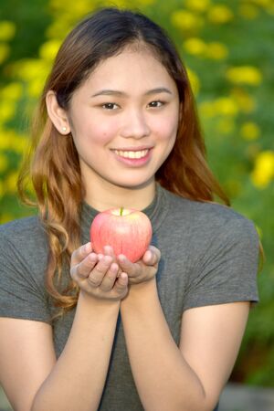 Smiling Young Female With An Apple
