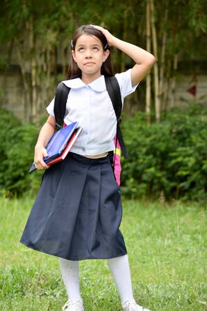 School Girl And Memory Loss Wearing School Uniform With Booksの写真素材
