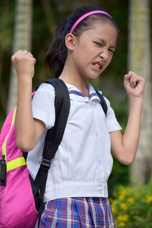Young Minority Female Student And Anger Wearing Uniform With Notebooksの写真素材
