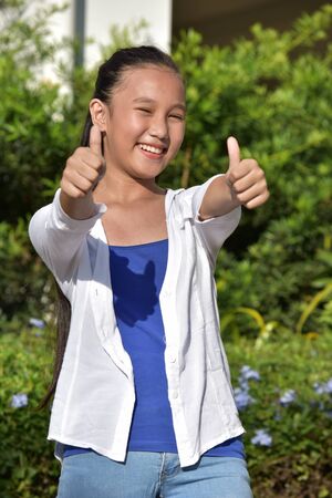 Youthful Diverse Girl With Thumbs Upの写真素材