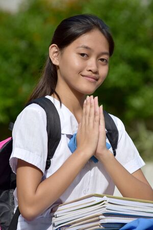A Pretty Filipina Girl Student Prayingの写真素材