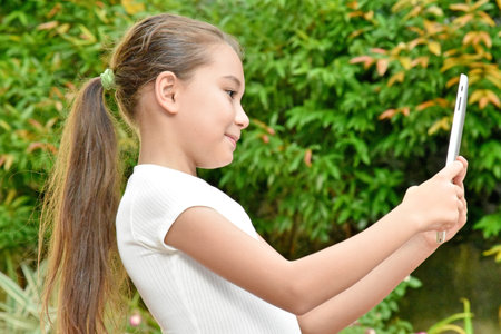 Philippina Female Child With Long Hair With Tabletの写真素材