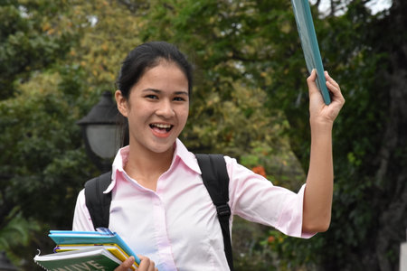 Youthful Filipina Student Teenager Smiling With School Books
