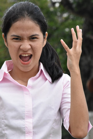 Mad Minority Female Juvenile Wearing Pink Shirt Portraitの写真素材