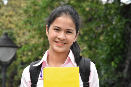 Smiling Youthful Female Student With Notebooksの写真素材