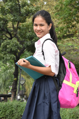 Filipina Student Teenager School Girl And Happiness Wearing Bookbag With Booksの写真素材