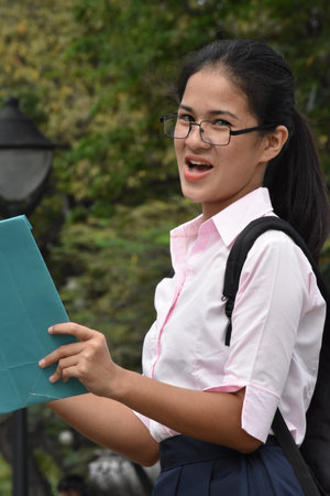 Unhappy Cute Diverse Girl Student With Notebooksの写真素材