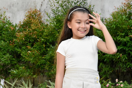 Filipina Girl With Irritated Eyes Outsideの写真素材
