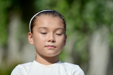 A Kid With Eyes Closed Outsideの写真素材